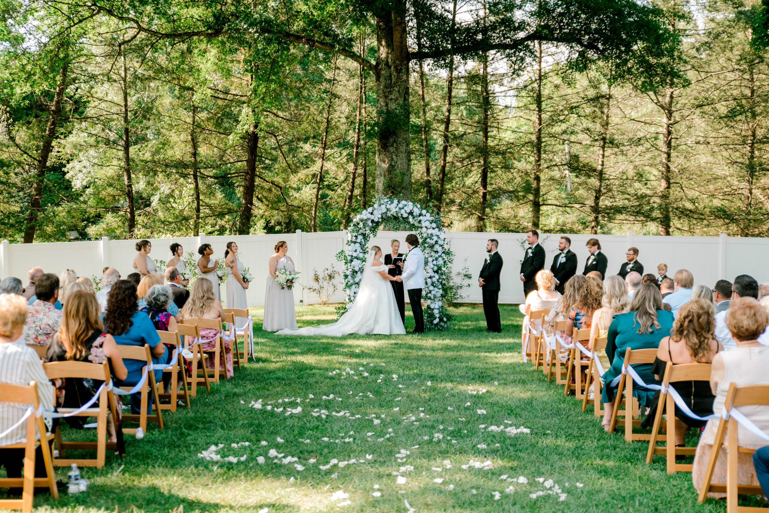 Outdoor ceremony on the patio at The Ellis House in Fairmont with black and white wedding décor